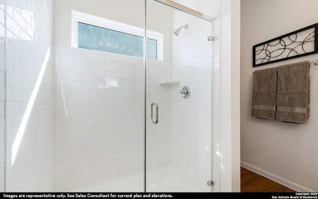 4948 Hawkwell Ln, San Antonio, TX 77584 - bathroom with a stall shower and wood finished floors