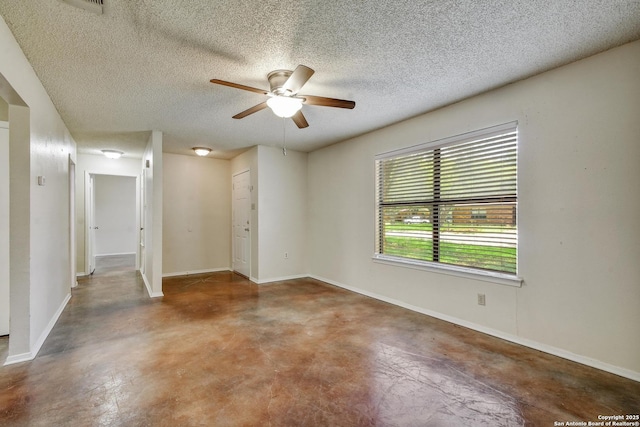 105 Apache, Cibolo, TX 78108 - spare room featuring finished concrete floors, a ceiling fan, and a textured ceiling