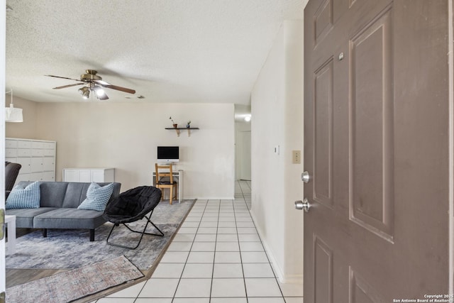 7643 Heathridge, San Antonio, TX 78250 - living room with light tile patterned flooring, a ceiling fan, and a textured ceiling