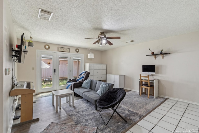7643 Heathridge, San Antonio, TX 78250 - living area featuring a ceiling fan, french doors, and a textured ceiling