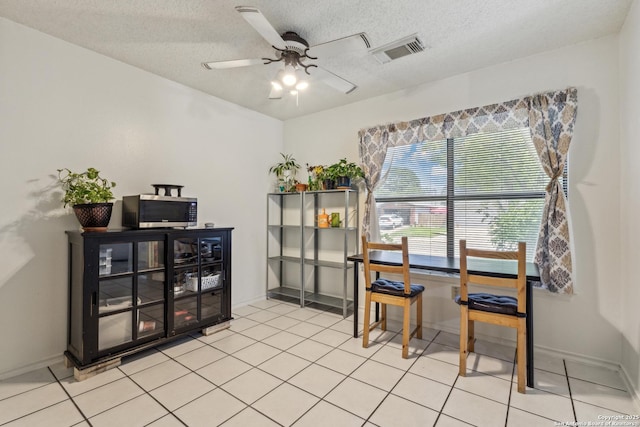 7643 Heathridge, San Antonio, TX 78250 - dining room featuring a ceiling fan, light tile patterned floors, and a textured ceiling