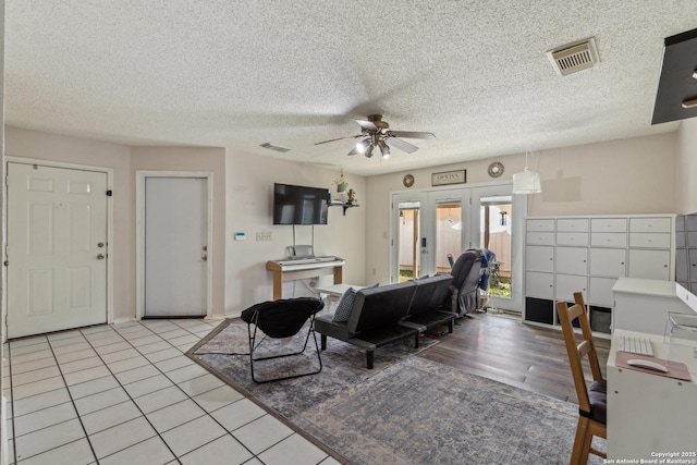 7643 Heathridge, San Antonio, TX 78250 - living room with ceiling fan, light tile patterned flooring, and a textured ceiling