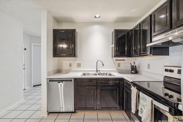 7643 Heathridge, San Antonio, TX 78250 - kitchen with stainless steel appliances, a textured ceiling, under cabinet range hood, light countertops, and light tile patterned floors