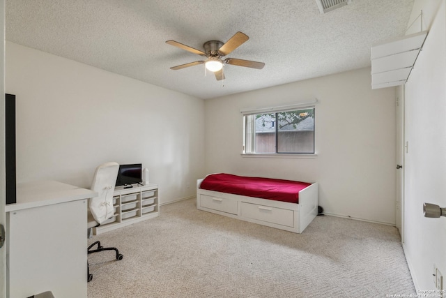 7643 Heathridge, San Antonio, TX 78250 - bedroom featuring carpet floors, an office area, a textured ceiling, and ceiling fan