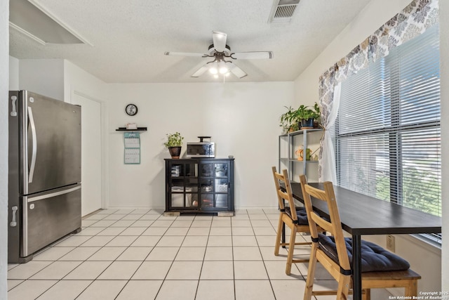 7643 Heathridge, San Antonio, TX 78250 - dining room featuring a ceiling fan, light tile patterned floors, and a textured ceiling
