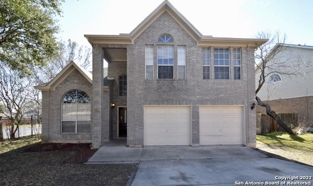 5103 Cabin Lake Dr, San Antonio, TX 78244 - view of front of home with driveway, a garage, and brick siding