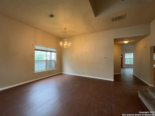 5103 Cabin Lake Dr, San Antonio, TX 78244 - spare room featuring dark wood-style flooring, a chandelier, and a textured ceiling