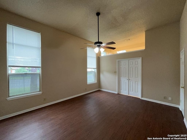 5103 Cabin Lake Dr, San Antonio, TX 78244 - unfurnished bedroom featuring dark wood-style floors, a textured ceiling, a ceiling fan, and a closet