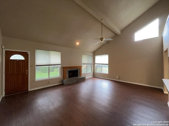 5103 Cabin Lake Dr, San Antonio, TX 78244 - unfurnished living room featuring a fireplace, dark wood-style floors, a ceiling fan, beamed ceiling, and high vaulted ceiling