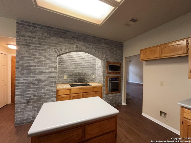 5103 Cabin Lake Dr, San Antonio, TX 78244 - kitchen with wall oven, dark wood-style floors, stainless steel microwave, light countertops, and black electric stovetop