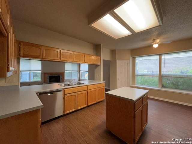 5103 Cabin Lake Dr, San Antonio, TX 78244 - kitchen featuring stainless steel dishwasher, dark wood finished floors, a ceiling fan, light countertops, and a center island