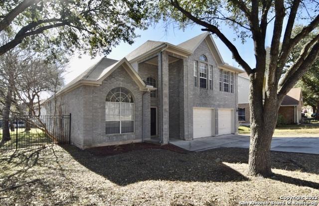 5103 Cabin Lake Dr, San Antonio, TX 78244 - traditional home with driveway, an attached garage, and brick siding