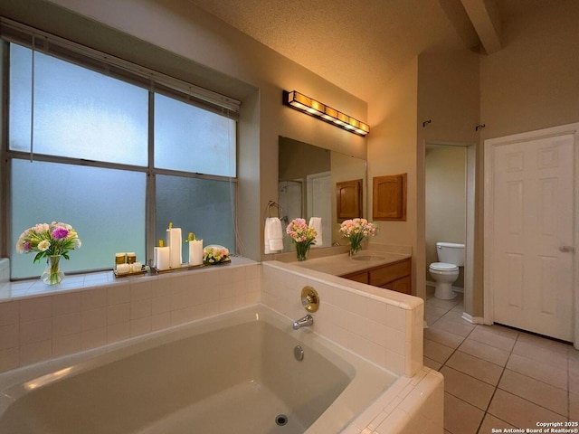5103 Cabin Lake Dr, San Antonio, TX 78244 - bathroom featuring lofted ceiling, tile patterned flooring, a garden tub, and vanity