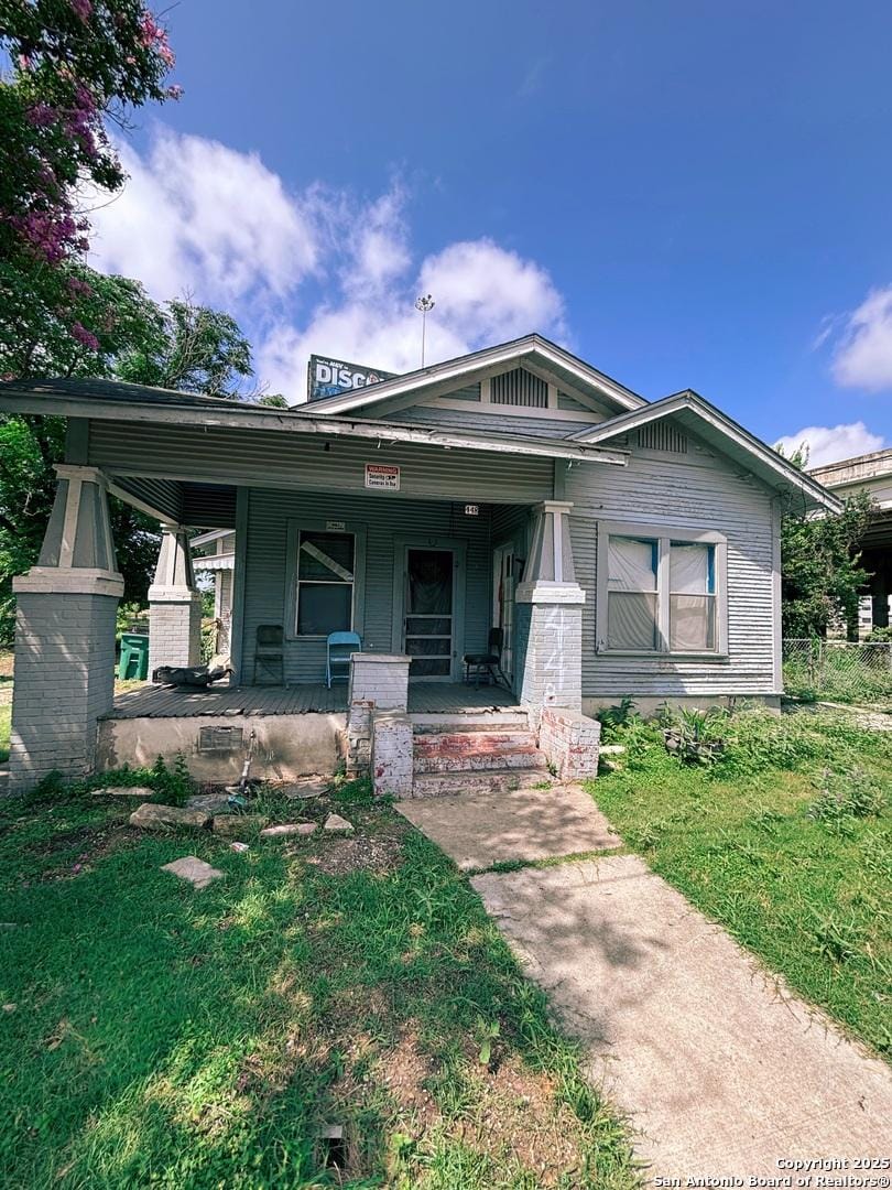 448 Furnish, San Antonio, TX 78204 - view of front of house featuring covered porch and a front lawn