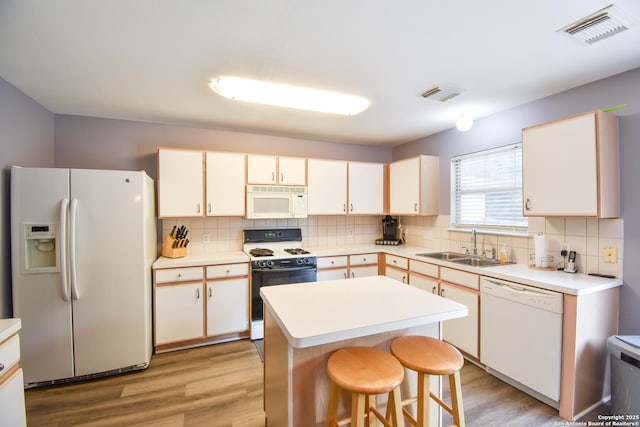 10310 Mission Crk, Converse, TX 78109 - kitchen featuring white appliances, tasteful backsplash, and light wood-type flooring