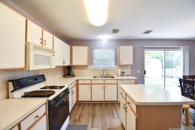 10310 Mission Crk, Converse, TX 78109 - kitchen with white appliances, light wood finished floors, light countertops, and backsplash
