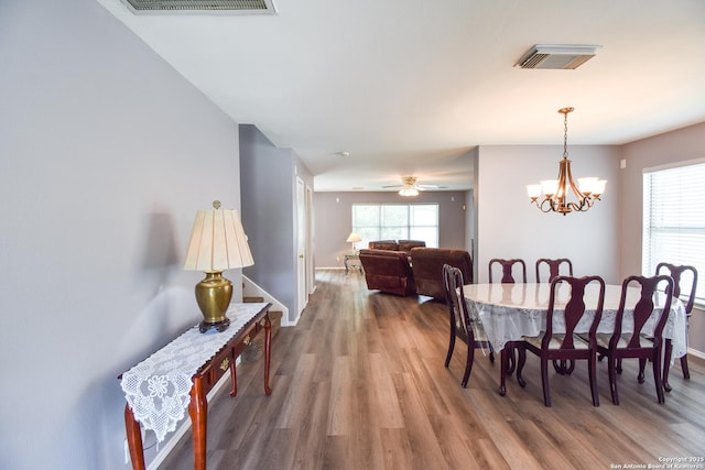 10310 Mission Crk, Converse, TX 78109 - dining space featuring wood finished floors, a chandelier, and a ceiling fan