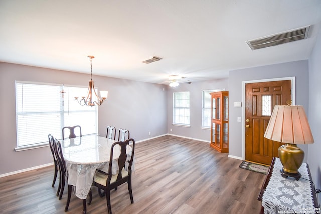 10310 Mission Crk, Converse, TX 78109 - dining area featuring wood finished floors, ceiling fan, and a chandelier