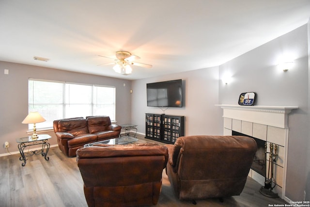 10310 Mission Crk, Converse, TX 78109 - living area featuring a ceiling fan, wood finished floors, and a tile fireplace