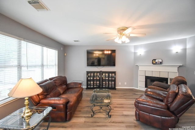 10310 Mission Crk, Converse, TX 78109 - living room with wood finished floors, ceiling fan, and a fireplace