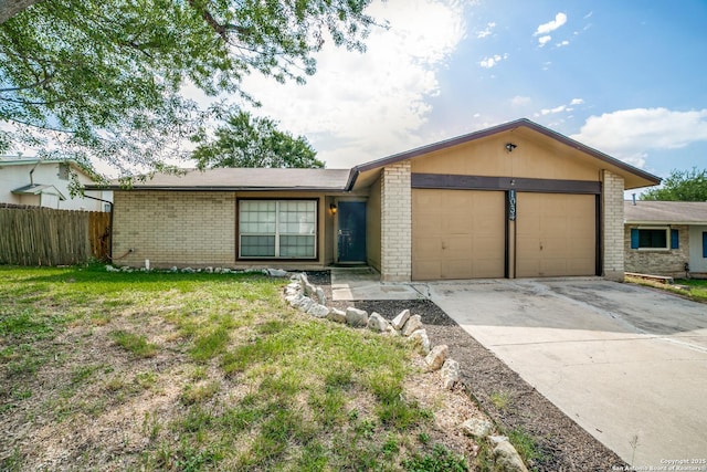 1034 Lemon Tree, San Antonio, TX 78245 - view of front facade featuring an attached garage, brick siding, and driveway