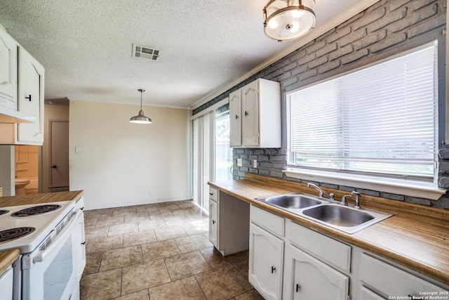 1034 Lemon Tree, San Antonio, TX 78245 - kitchen featuring white cabinets, white range with electric cooktop, decorative light fixtures, a textured ceiling, and ornamental molding
