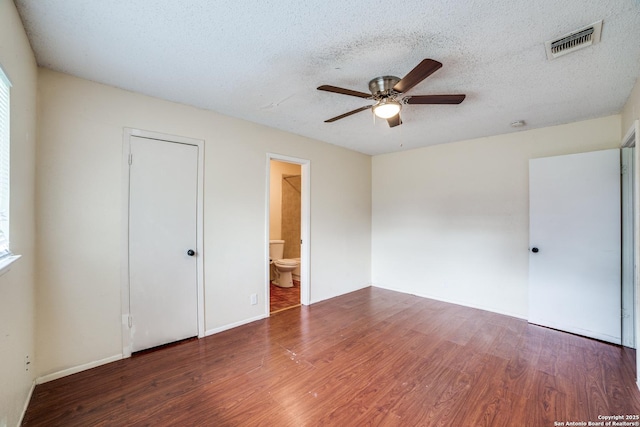 1034 Lemon Tree, San Antonio, TX 78245 - unfurnished bedroom featuring wood finished floors, a textured ceiling, a ceiling fan, and connected bathroom