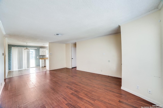 1034 Lemon Tree, San Antonio, TX 78245 - spare room featuring crown molding, dark wood-type flooring, and a textured ceiling