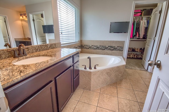 5938 Akin Song, San Antonio, TX 78261 - full bathroom with vanity, a garden tub, tile patterned flooring, and a spacious closet