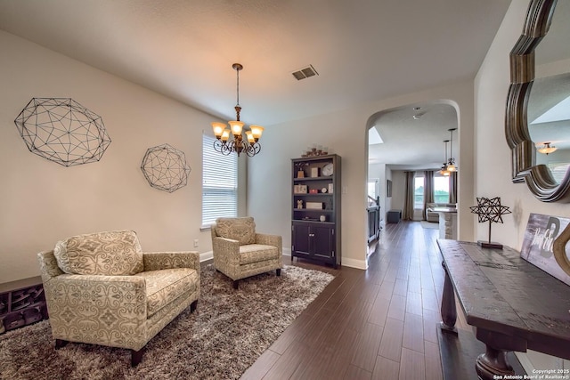 5938 Akin Song, San Antonio, TX 78261 - sitting room with arched walkways, dark wood-style flooring, and a chandelier