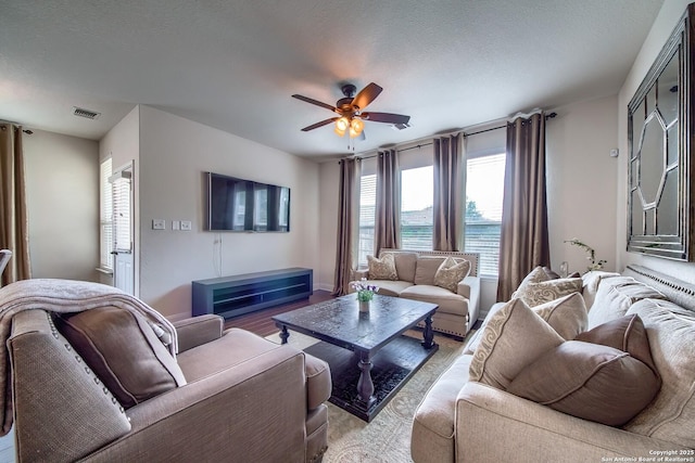 5938 Akin Song, San Antonio, TX 78261 - living room with ceiling fan and a textured ceiling