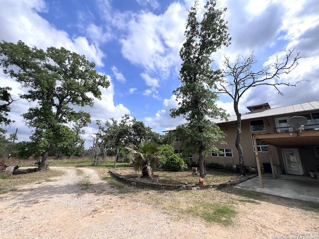 184 Guadalupe Hls, Seguin, TX 78155 - view of yard with a patio area, dirt driveway, and a carport