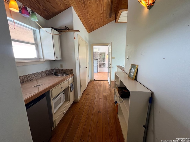 184 Guadalupe Hls, Seguin, TX 78155 - kitchen with wooden ceiling, tile counters, wood-type flooring, white microwave, and vaulted ceiling
