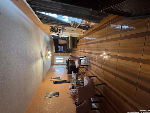 211 Wilcox, San Antonio, TX 78211 - living area featuring wood walls and a textured wall
