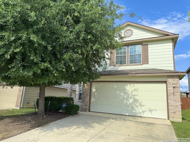 130 Palazzo Torre, San Antonio, TX 78253 - view of front facade with an attached garage, brick siding, and concrete driveway
