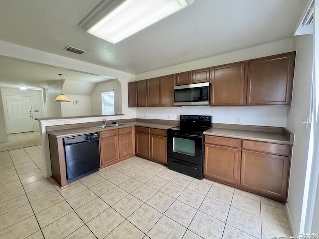 130 Palazzo Torre, San Antonio, TX 78253 - kitchen featuring black appliances, light tile patterned floors, a peninsula, pendant lighting, and lofted ceiling