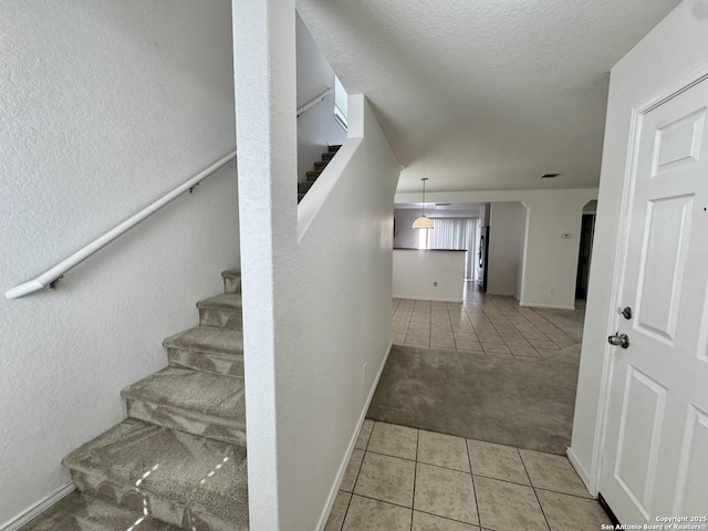130 Palazzo Torre, San Antonio, TX 78253 - stairway with tile patterned flooring, carpet flooring, a textured wall, and a textured ceiling