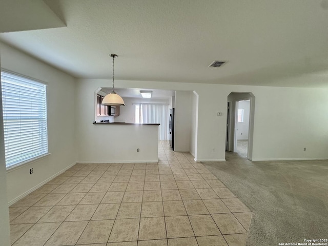 130 Palazzo Torre, San Antonio, TX 78253 - empty room featuring healthy amount of natural light, arched walkways, and light tile patterned flooring