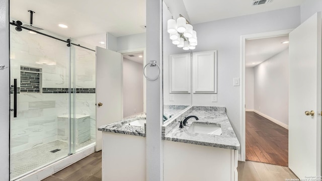 2530 Melrose Cyn, San Antonio, TX 78232 - bathroom with a shower stall, double vanity, wood finished floors, and recessed lighting