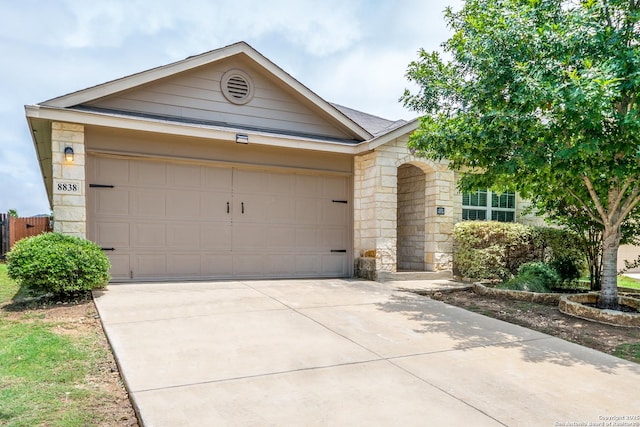 8838 Palmetto Fls, San Antonio, TX 78254 - view of front of property featuring stone siding, driveway, and a garage