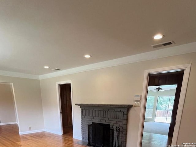 117 Bryker, Terrell Hills, TX 78209 - unfurnished living room featuring recessed lighting, light wood-style flooring, a brick fireplace, crown molding, and a ceiling fan