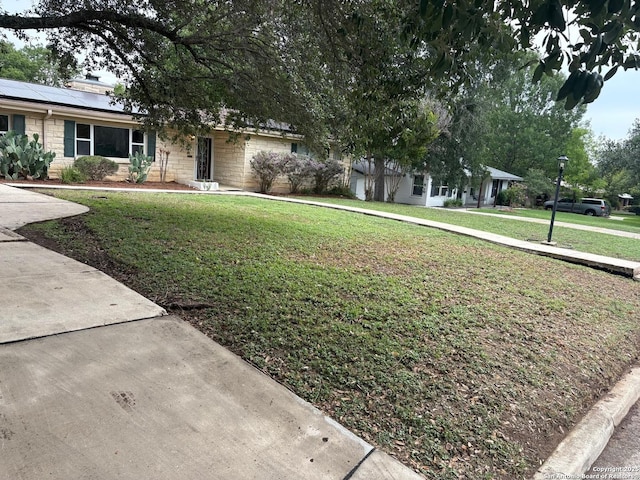 117 Bryker, Terrell Hills, TX 78209 - view of front of property featuring a front lawn, roof mounted solar panels, and stone siding