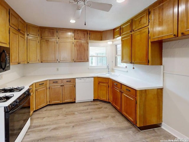 117 Bryker, Terrell Hills, TX 78209 - kitchen with white dishwasher, gas range oven, a ceiling fan, black microwave, and light wood finished floors