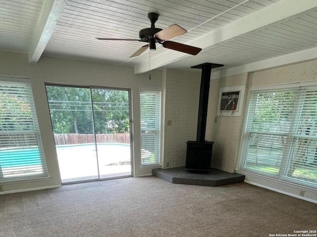 117 Bryker, Terrell Hills, TX 78209 - unfurnished living room with beam ceiling, a wood stove, carpet floors, and a ceiling fan