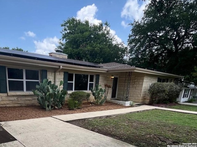 117 Bryker, Terrell Hills, TX 78209 - single story home featuring stone siding, solar panels, and a chimney