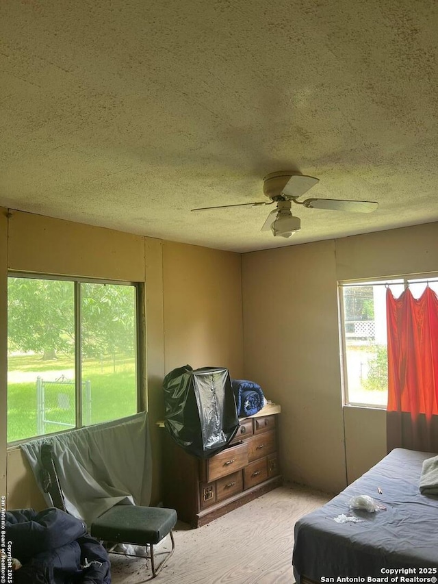 168 Water St, Pipe Creek, TX 78063 - bedroom with a textured ceiling and ceiling fan