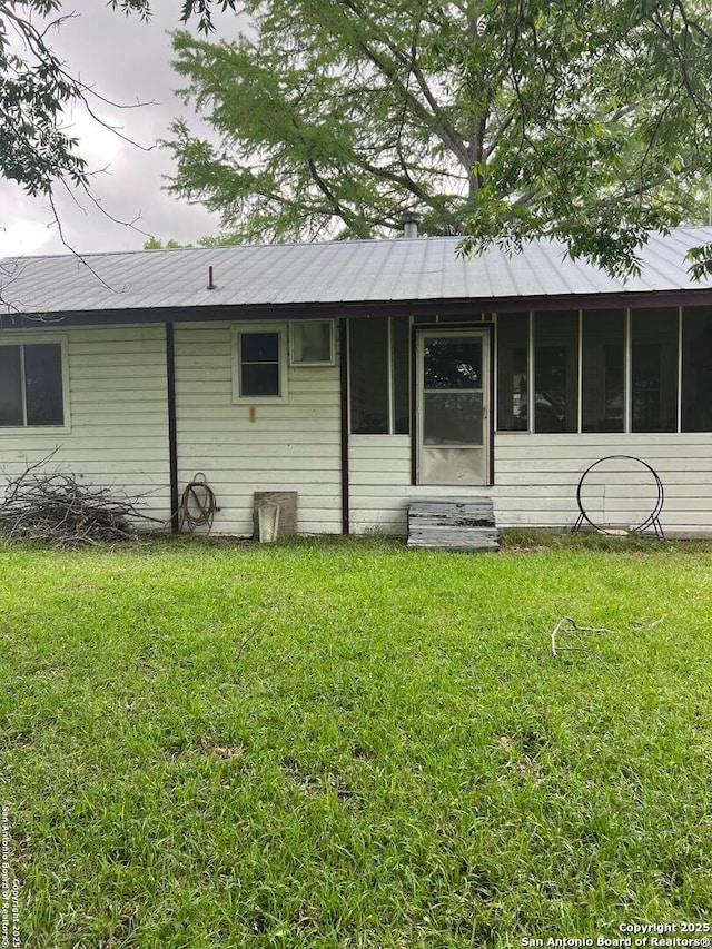 168 Water St, Pipe Creek, TX 78063 - back of property featuring a lawn and a sunroom