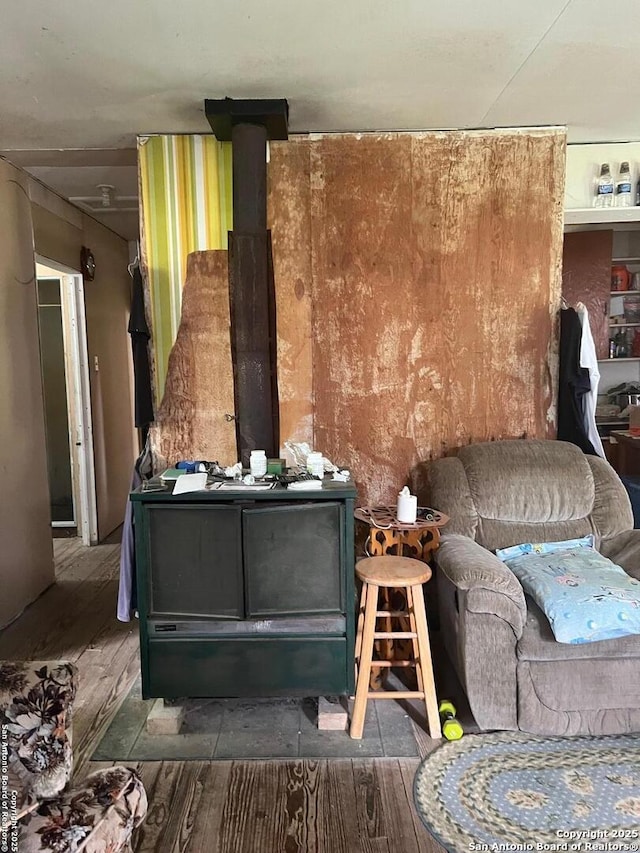 168 Water St, Pipe Creek, TX 78063 - living area featuring a wood stove and wood finished floors