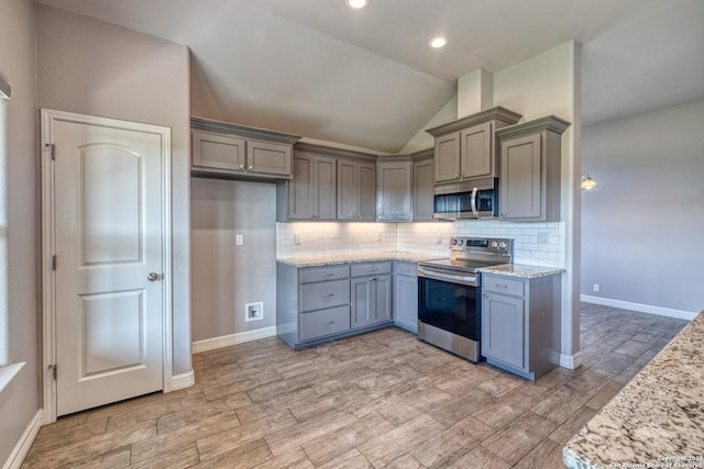 13 Hope, Uvalde, TX 78801 - kitchen featuring appliances with stainless steel finishes, gray cabinets, vaulted ceiling, light wood finished floors, and recessed lighting