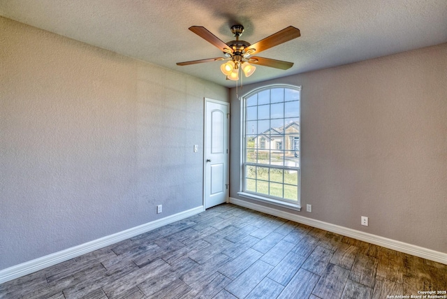 13 Hope, Uvalde, TX 78801 - spare room featuring wood finished floors, healthy amount of natural light, a ceiling fan, and a textured ceiling